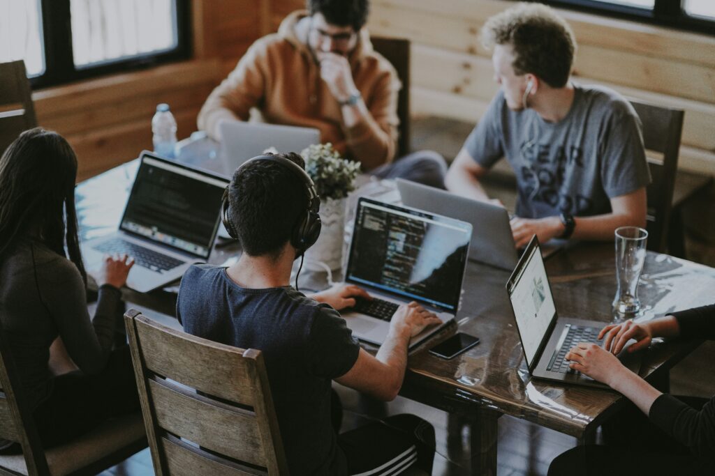 Colleagues collaborating at a laptop in a bright office